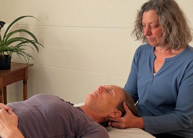 Zero Balancing being done in an office with white walls